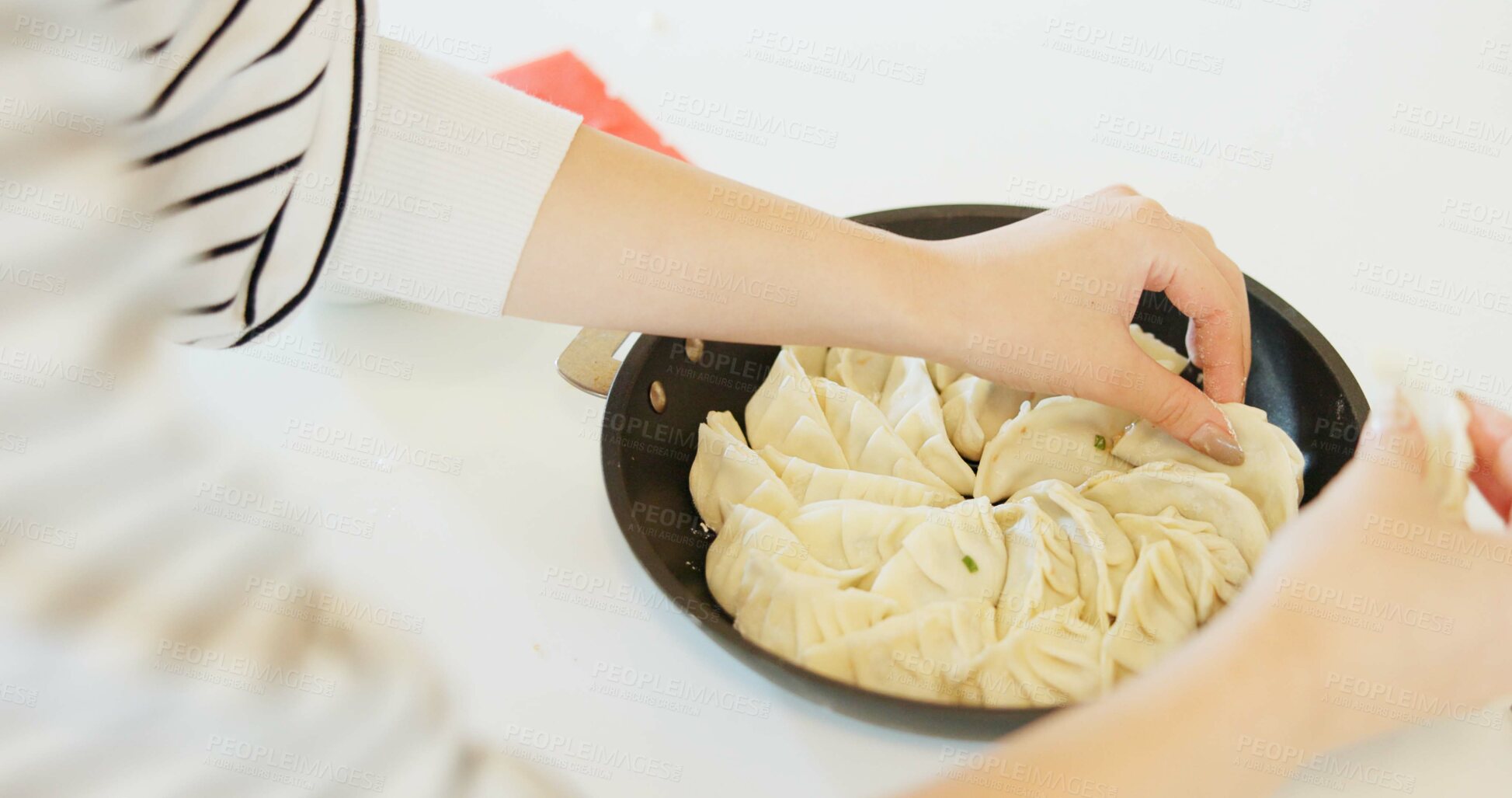 Buy stock photo Japan, hands and dumplings on table for dinner, brunch and traditional meal in restaurant or cafe. Culture, gyozo and asian cuisine for nutrition, healthy diet and lunch with preparation or pastry