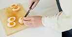 Chef hands, knife and boiled eggs in kitchen for cooking, protein or prepare food for catering service. Person, chopping board and ready for cuisine, fine dining or nutrition on table in restaurant