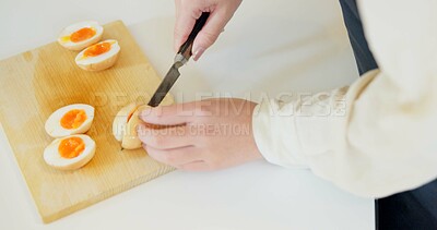 Buy stock photo Chef hands, knife and boiled eggs in kitchen for cooking, protein or prepare food for catering service. Person, chopping board and ready for cuisine, fine dining or nutrition on table in restaurant