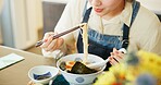 Japanese woman, eating ramen and restaurant with chopsticks, hungry and lunch for nutrition. Girl, person and meal for health, wellness and diet with noodles at cafeteria, diner and brunch in Tokyo