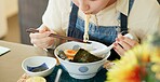 Hungry woman, eating ramen and restaurant with chopsticks, noodles and lunch for nutrition. Girl, person and meal for health, wellness and diet for wellness at cafeteria, diner and brunch in Tokyo