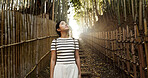 Nature, bamboo path and Japanese woman for freedom on holiday, vacation and morning in outdoor woods. Thinking, relax and person in forest, track and trail to explore, walking and adventure in Kyoto