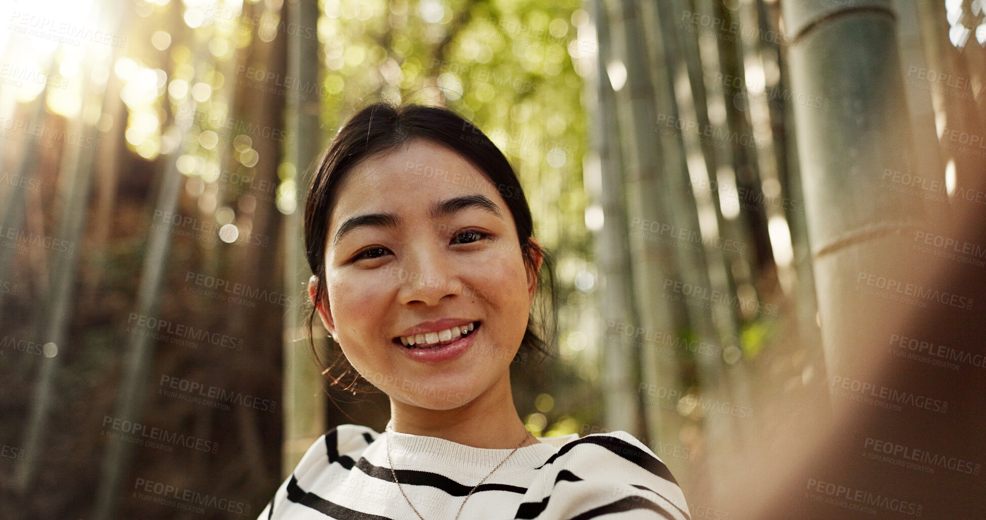 Buy stock photo Japanese woman, portrait and selfie in forest with smile, pride and bamboo in bush for post on web blog. Girl, person and happy influencer on adventure, trekking or hiking by trees for social media