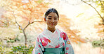 Culture, park and portrait of Japanese woman for wellness, fresh air and relax outdoors in nature. Travel, culture and happy person in indigenous clothes, fashion and kimono for zen, calm and peace