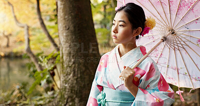 Buy stock photo Thinking, traditional and Japanese woman in park for wellness, fresh air and relax with umbrella outdoors. Travel, culture and person in indigenous clothes, style and kimono for peace in nature