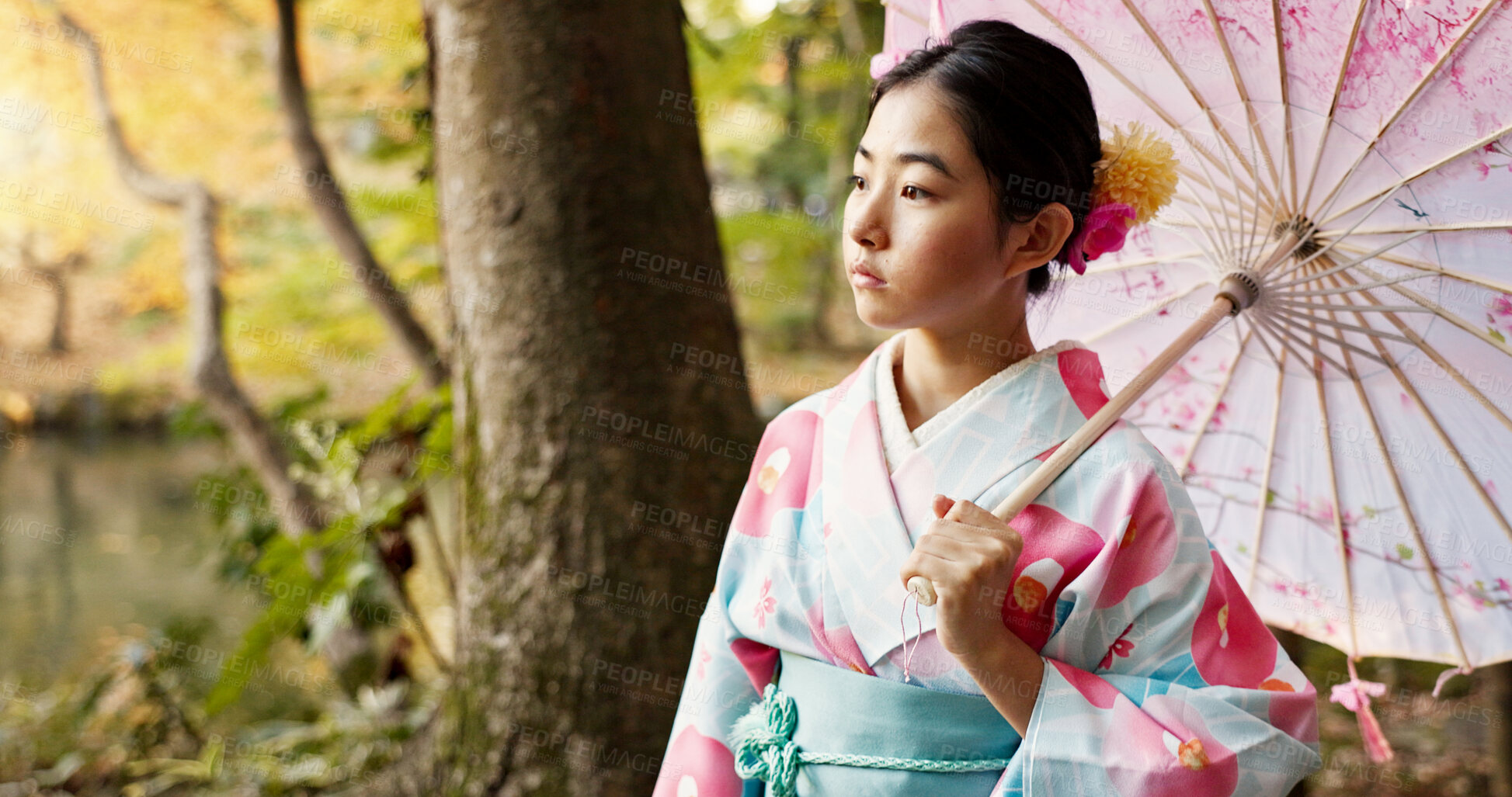 Buy stock photo Thinking, traditional and Japanese woman in park for wellness, fresh air and relax with umbrella outdoors. Travel, culture and person in indigenous clothes, style and kimono for peace in nature