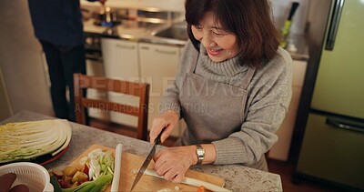 Buy stock photo Cooking, smile and Japanese woman in kitchen cutting vegetables for meal, dinner or lunch. Happy, positive and senior female person preparing food for supper together with produce at modern home.