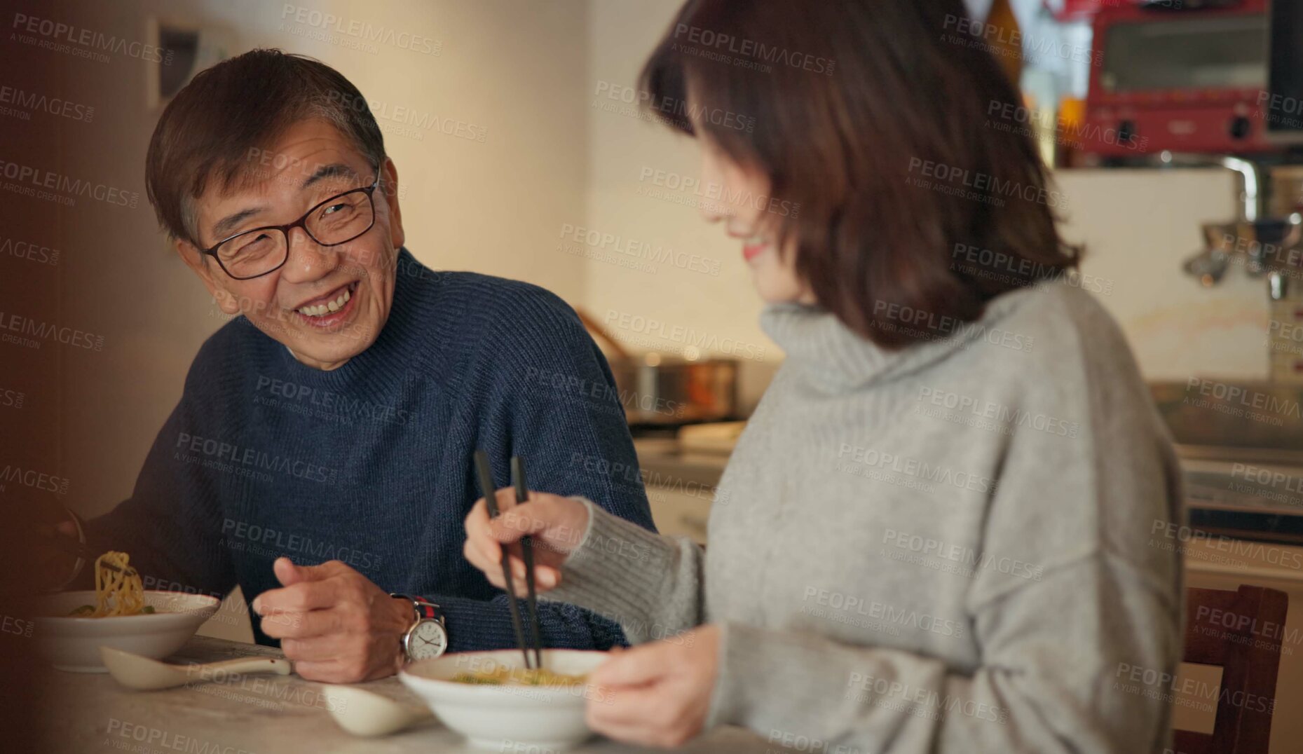 Buy stock photo Japanese couple, food and home with conversation, love and bonding together with happiness, romance and smile. Apartment, old man or senior woman with healthy meal, nutrition and cheerful with dinner