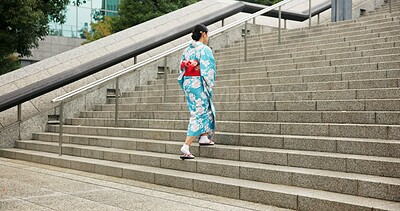 Buy stock photo Woman, Japanese and walking in kimono for traditional on stairs in Tokyo for wellness, health or peace. Female person, outdoor and urban city explore for downtown commute for local, steps or culture