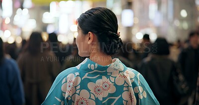 Buy stock photo Back, city and Japanese woman in kimono on street with crowd for culture, heritage or tradition. Travel, fashion and person walking on road of urban Tokyo town at night for vacation or sightseeing