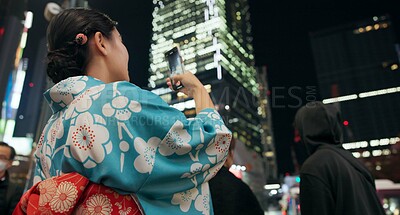 Buy stock photo Japanese woman, picture and night with smartphone, social media and connection with network, traditional clothes and journey. Digital app, evening and person with a cellphone, blog post and adventure