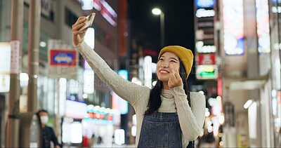 Buy stock photo Heart, hands and selfie by Japanese woman in a city for travel, adventure or journey outdoor. Love, emoji or happy lady influencer in Japan for content creation, blog or social media live streaming