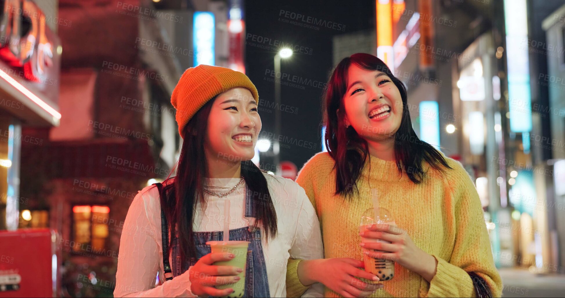 Buy stock photo Night, travel and Japanese women in a city walking, talking and bonding with milkshake drink outdoor. Happy, female and friends in Japan with bubble tea boba, conversation and fun evening adventure