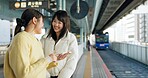 Woman, friends and train station or cellphone for travel, Japanese or social media. Female people, digital device and communication in Tokyo for public transport or vacation commute, urban or journey