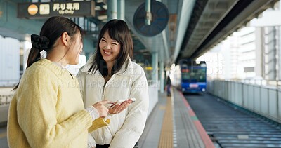 Buy stock photo Women, friends and train station or cellphone or Japanese, travel or social media. Female people, digital device and communication in Tokyo for public transport or vacation commute, urban or journey