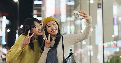 Buy stock photo Friends, Japanese and selfie with women, happy and excited with adventure, profile picture and social media. People, smartphone or girls with night, fun and bonding together with pose and peace sign