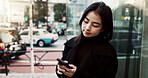 Phone, city and Japanese woman on social media, reading email or notification in Tokyo. Smartphone, girl and person on mobile in urban street outdoor for communication technology, network or internet