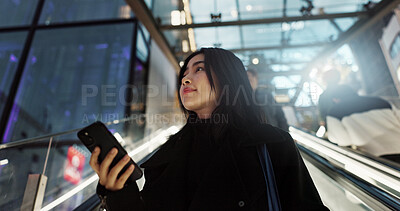 Buy stock photo Japanese, woman on escalator and phone, travel and commute, communication with social media and adventure. Text, email and online chat with connectivity, subway or airport with mobile app in Japan