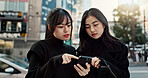 Phone, friends and women in city for travel, social media and connection together in Japan. Smartphone, girls and people in urban street outdoor on app, information or network on technology in Tokyo