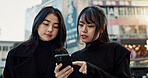 Japanese women friends, phone and street with talk, thinking and check direction for travel location. Girl people, smartphone and outdoor in city with digital map, search or chat on vacation in Tokyo