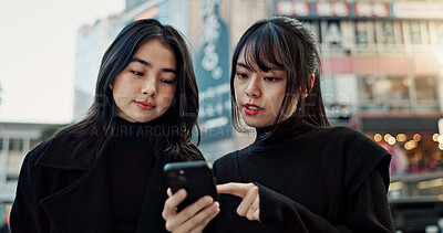 Buy stock photo Japanese women friends, phone and street with talk, thinking and check direction for travel location. Girl people, smartphone and outdoor in city with digital map, search or chat on vacation in Tokyo