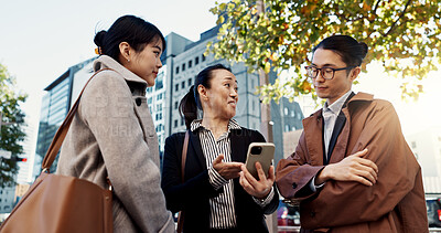 Buy stock photo Phone, business and group of people in city on internet, social media or reading email together in Japan. Smartphone, happy and friends in urban town on technology, networking and mobile app in Tokyo