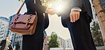Business people, handshake and city for partnership, deal or agreement in teamwork with lens flare. Closeup of employees shaking hands in meeting for travel, greeting or outdoor collaboration in town
