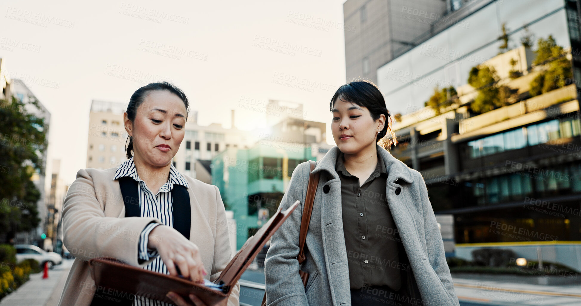 Buy stock photo Documents, walking and Japanese business people in city for morning commute, travel and discussion. Collaboration, corporate team and women with paperwork for meeting, talking and project in Tokyo