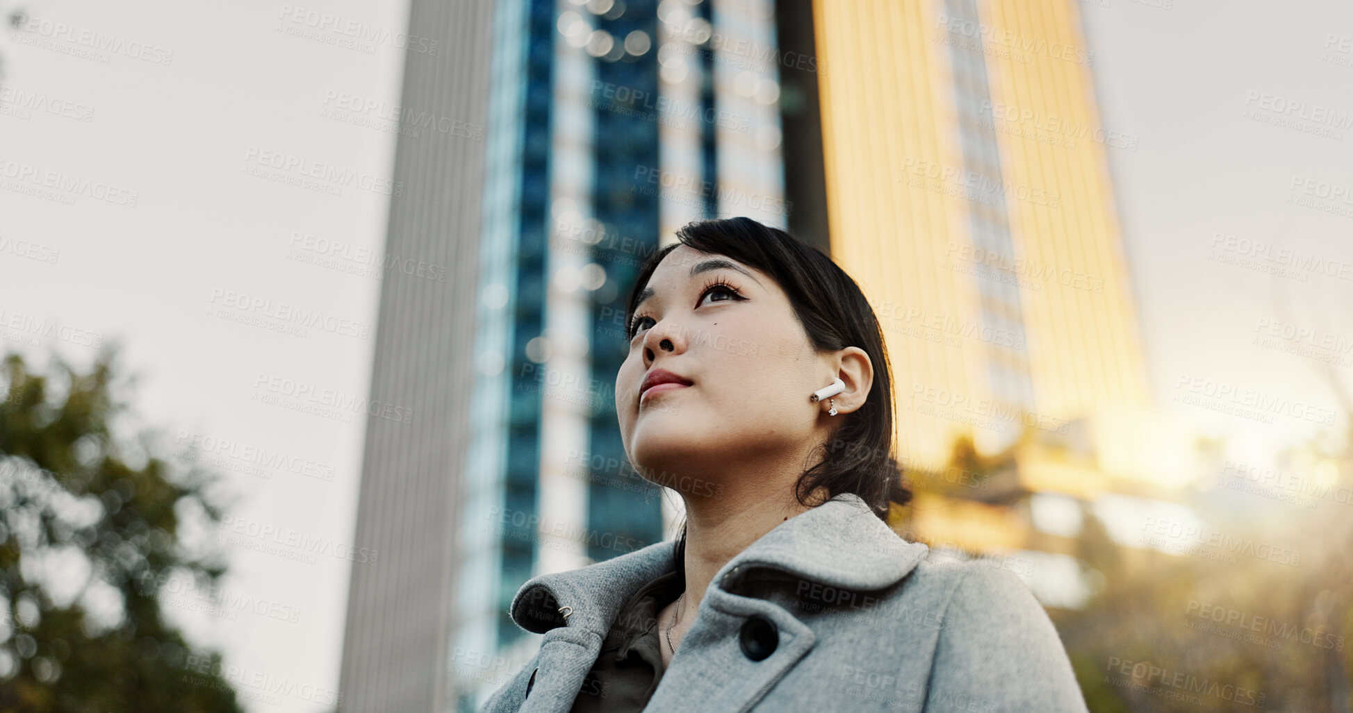 Buy stock photo Thinking, city and business Japanese woman with music on morning commute, travel and walking in Tokyo. Earphones, corporate worker and person with ideas, ambition and future for career, work and job 