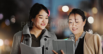 Japanese women, tablet and street in night with smile, documents and working late with application. Business people, partnership and happy for results, paperwork and project with touchscreen in Tokyo