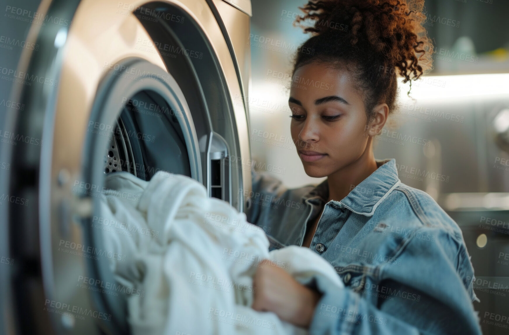 Buy stock photo Woman, laundry and clean clothes loaded into a washing machine for laundromat, chores or self service. Black, young girl or teenager doing cleaning duties for hygiene, cleanliness and housework