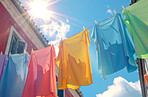 Cloth, laundry or colourful fabric hanging on a washing line for laundromat business, textile and background. Blue sky, summer day and springtime wallpaper for clean clothes and eco friendly washing