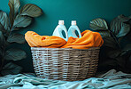 Clean, laundry and clothes in a washing basket at laundromat, home and self service. Fresh, hygienic and closeup of pile of clothing for textile, colourful fabric softener and cleaning duties