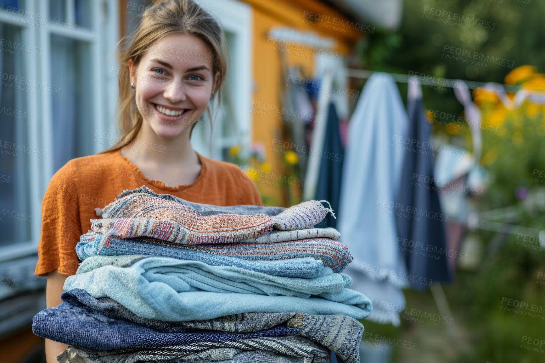 Buy stock photo Woman, laundry pile and clean clothes for laundromat service, fabric softener and household chores. Friendly, happy and content young girl holding folded clothing for cleaning services and hygiene