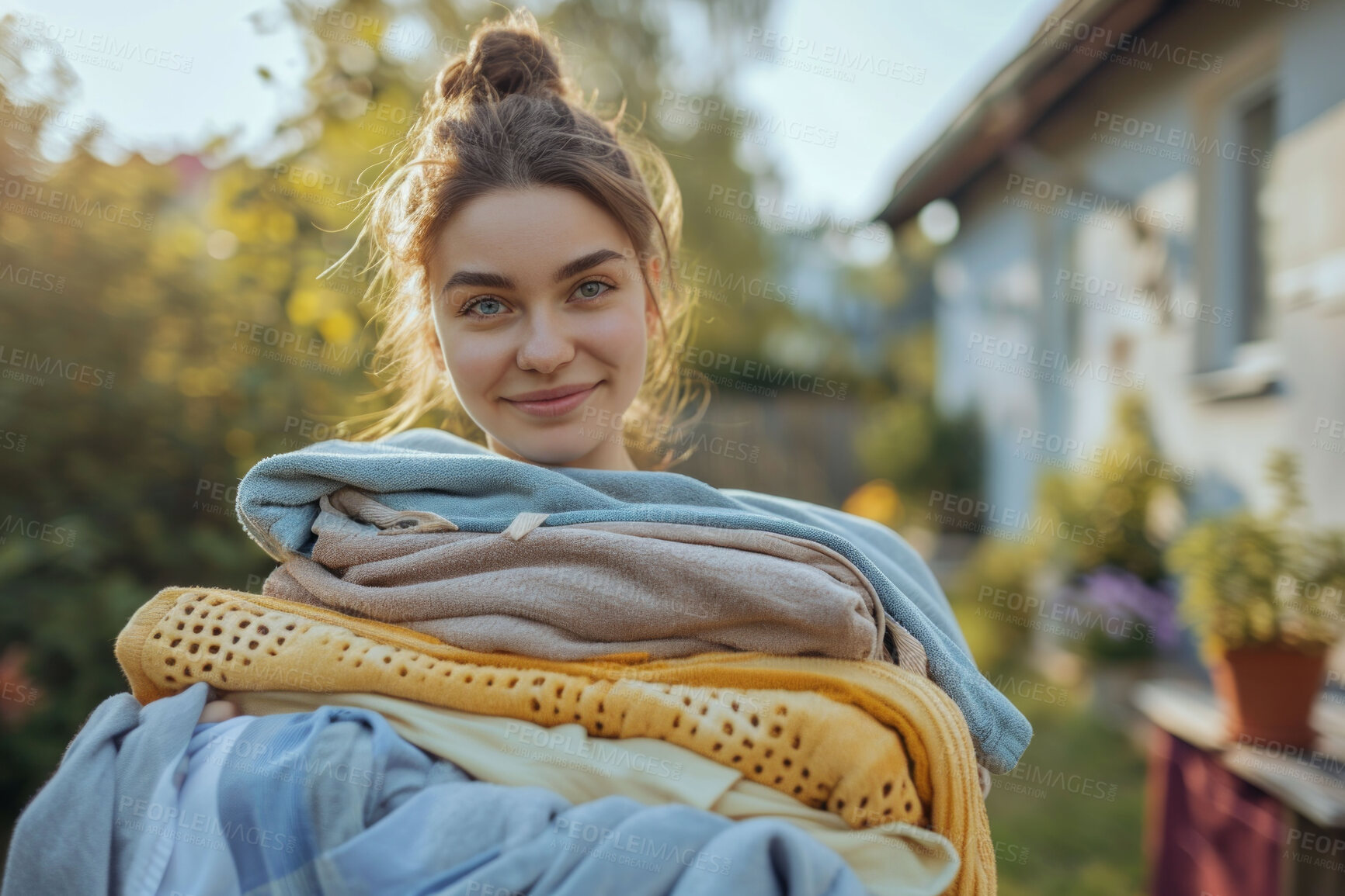 Buy stock photo Woman, laundry pile and clean clothes for laundromat service, fabric softener and household chores. Friendly, happy and content young girl holding folded clothing for cleaning services and hygiene