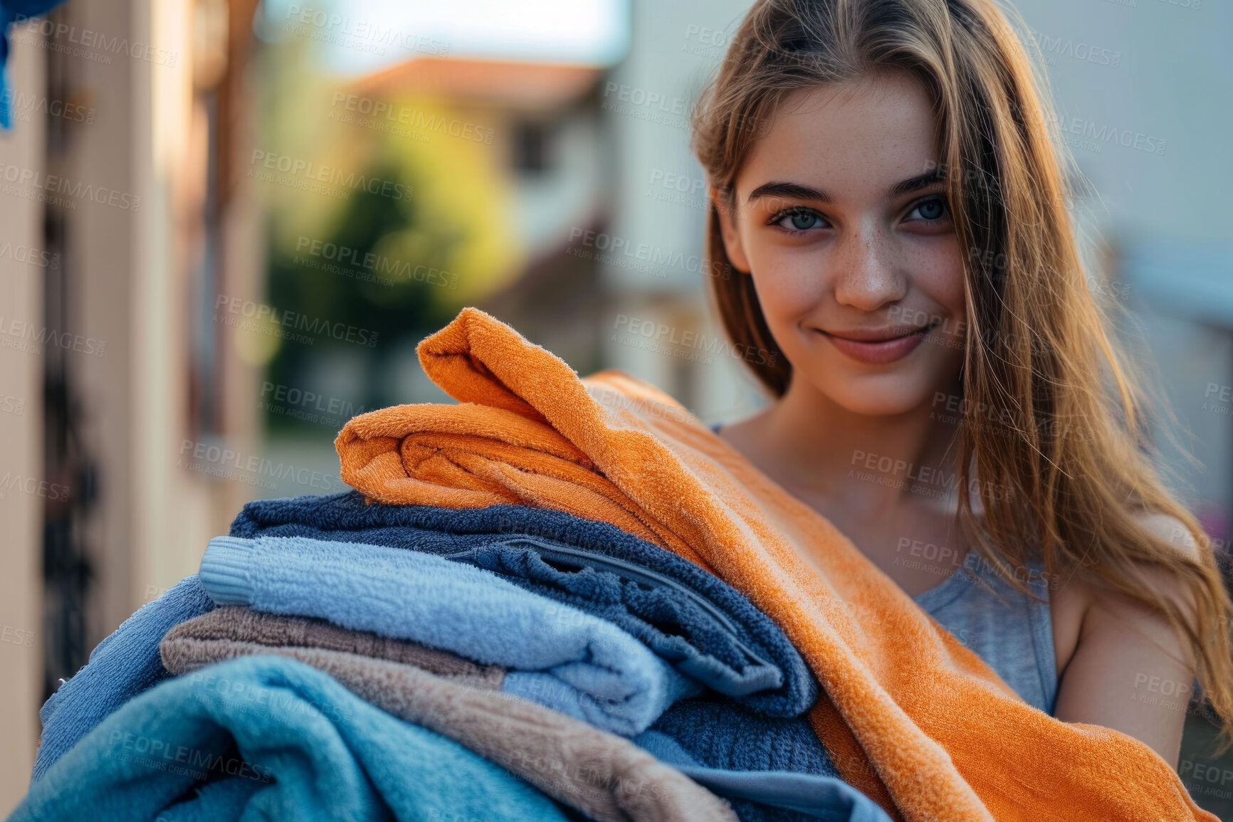 Buy stock photo Woman, laundry pile and clean clothes for laundromat service, fabric softener and household chores. Friendly, happy and content young girl holding folded clothing for cleaning services and hygiene