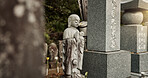 Buddha, statue and tombstone in graveyard with child for safety, protection and sculpture outdoor in nature. Jizo, Japan and memorial gravestone with history, culture and monument for sightseeing