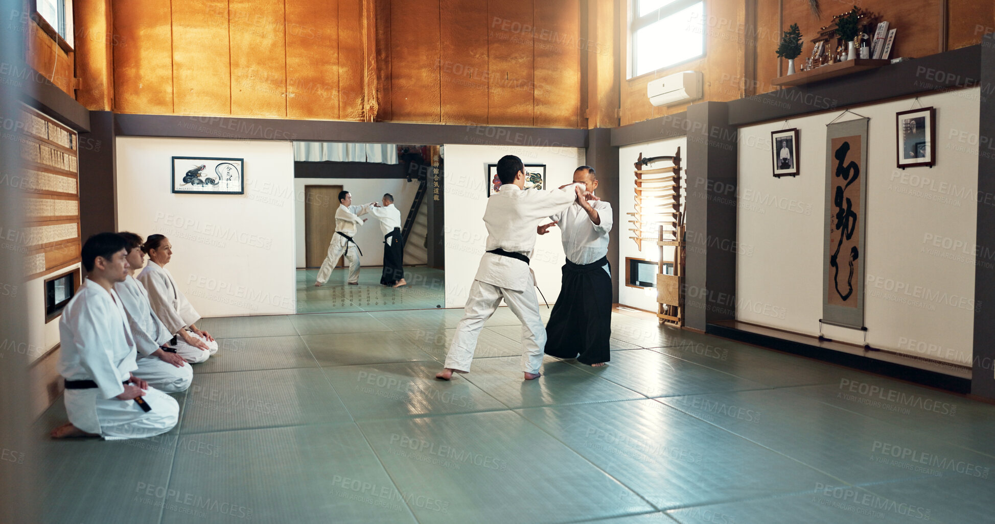 Buy stock photo Aikido, sensei and Japanese students with training, fitness and action in class for defence or technique. Martial arts, people or fighting with discipline, uniform or confidence for culture and skill