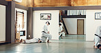 Students, karate or people learning in dojo for fitness, martial arts discipline or self defense combat. Demonstration, workout or kung fu master training athletes for fighting, education or class