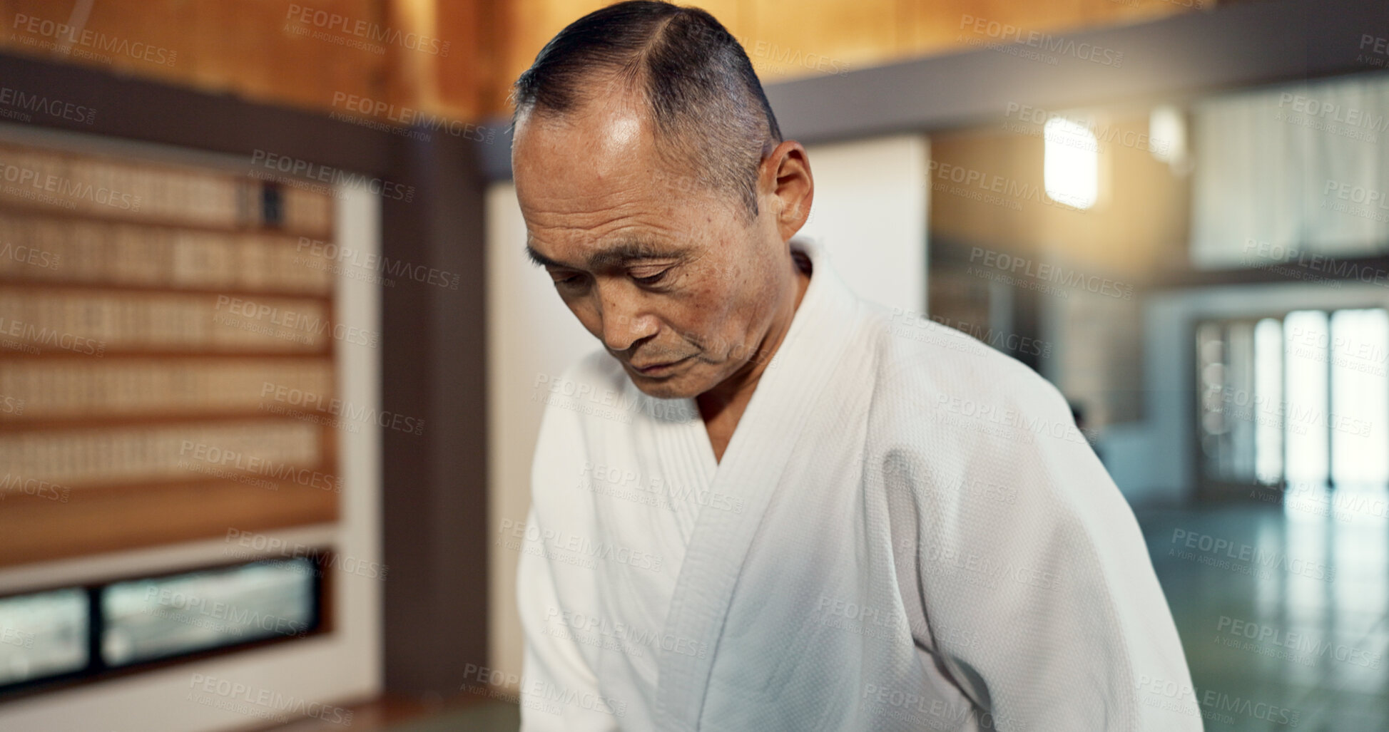 Buy stock photo Japanese sensei, aikido and instructor for fighting, modern martial arts and class in self defence. Teacher, respect and bow as trainer in life energy, man and strong in coaching in dojo place