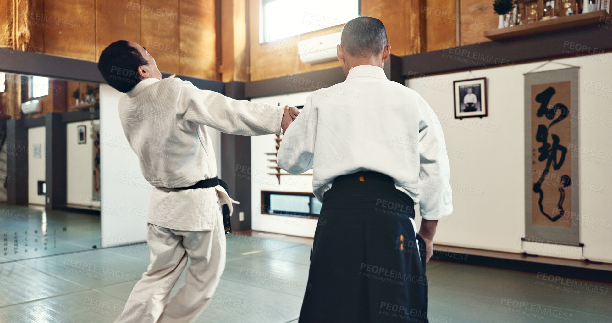 Buy stock photo Aikido, master and fight with a sensei in martial arts with student of self defence, discipline and training. Demonstration, class or Japanese man with black belt in fighting with education of skill