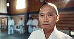 Sensei, aikido and training dojo for martial arts practice or Japanese traditional sport, fighting or health. Male person, gee uniform and face for fitness challenge or power, champion or confidence