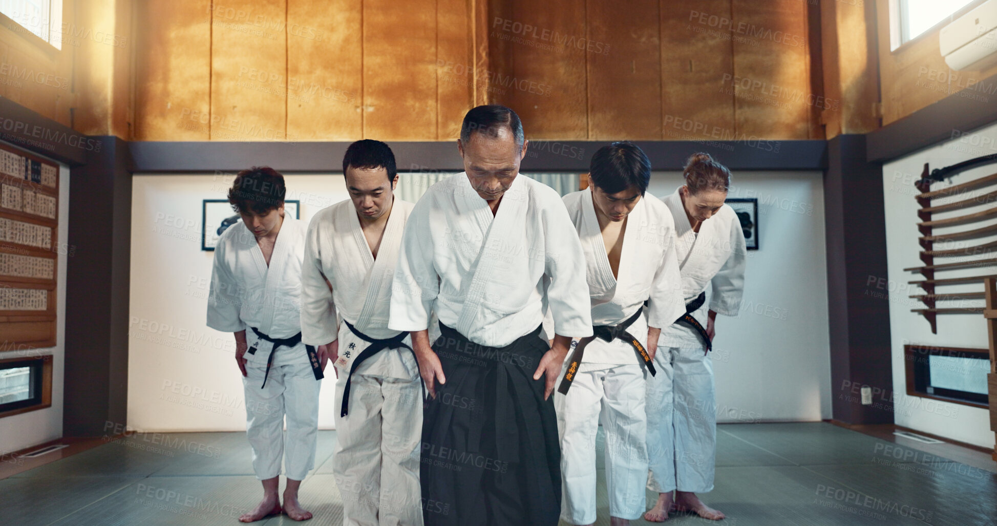 Buy stock photo Martial arts group, men and bow for exercise, respect or honor for fight, conflict or competition in dojo. Senior Japanese sensei, black belt students and aikido with training, workout or discipline