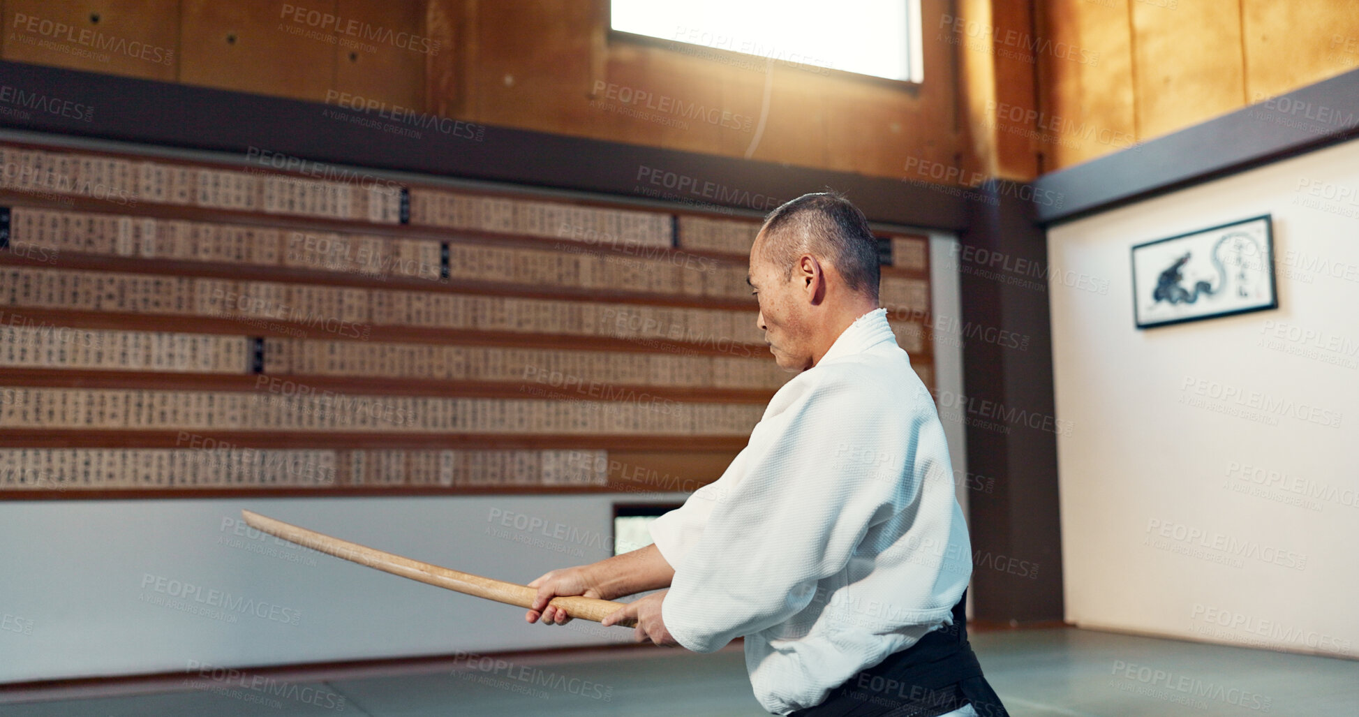 Buy stock photo Aikido sword, mature sensei and man teaching class, self defense or combat technique. Martial arts, Japanese person and wooden weapon for skills development, attack demonstration or bokken strike