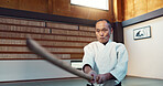 Aikido sword, martial arts and mature man strike for training, self defense or combat technique. Dojo, Japanese person and expert with wooden weapon for skills development, attack or bokken practice