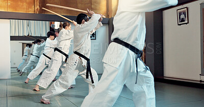Buy stock photo Martial arts, aikido class and people with training discipline, self defense and practice sword technique. Black belt students, Japanese group and learning skills development for protection in dojo