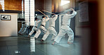 Aikido, dojo class and people training for self defense, combat and Japanese group practice sword technique. Black belt students, transparent window and learning martial arts for safety protection
