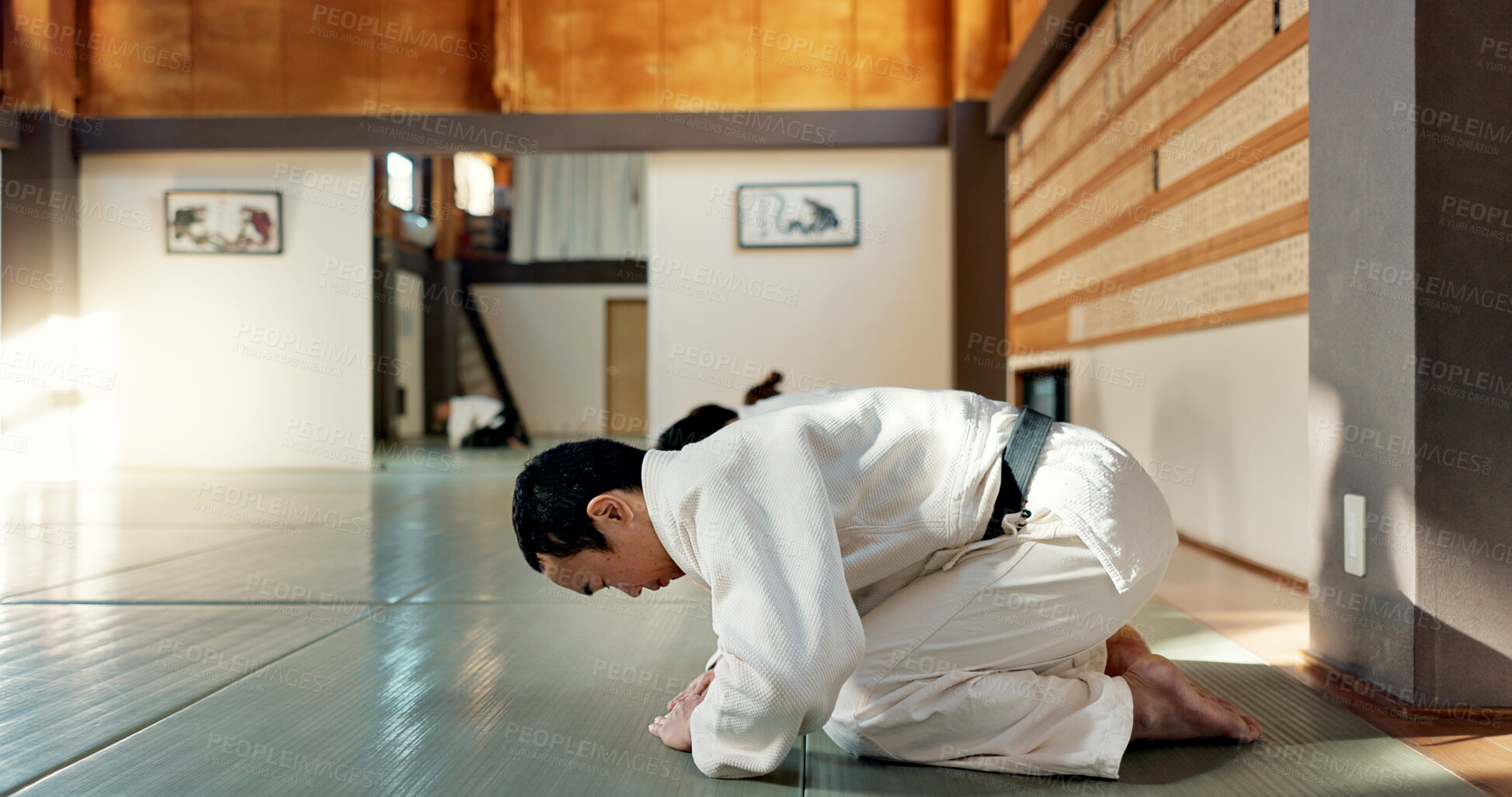 Buy stock photo Asian man, class and bow in dojo for respect, greeting or honor to master at indoor gym. Male person or group in karate bowing on floor for etiquette, attitude or commitment in martial arts together