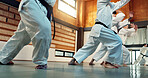 Students, Japanese people in aikido class for fitness and martial arts training class with self defense and discipline. Combat, fight and education, black belt with workout for exercise in dojo