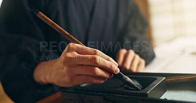 Hands, reed pen or brush in ink for writing, calligraphy or ancient script for art and inkstone. Japanese creativity, black paint and vintage tools, paintbrush and stroke, traditional and stationery